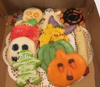 A plate of halloween cookies on top of a table.