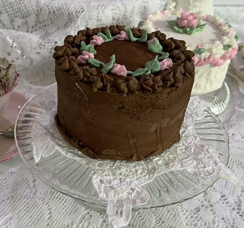 A chocolate cake sitting on top of a glass plate.