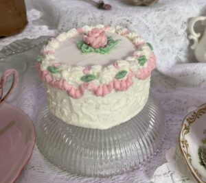 A small cake on top of a glass plate.