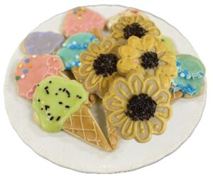 A plate of cookies and ice cream on top of the table.